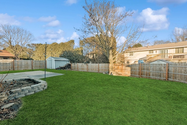 view of yard with a storage shed and a patio area