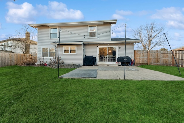 back of property with a patio area and a lawn