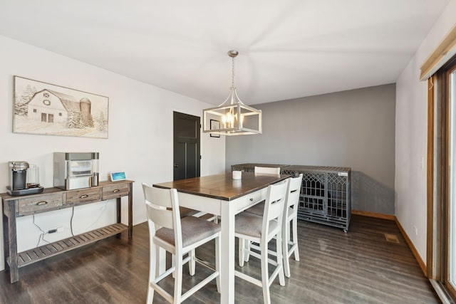 dining space featuring an inviting chandelier and dark hardwood / wood-style floors