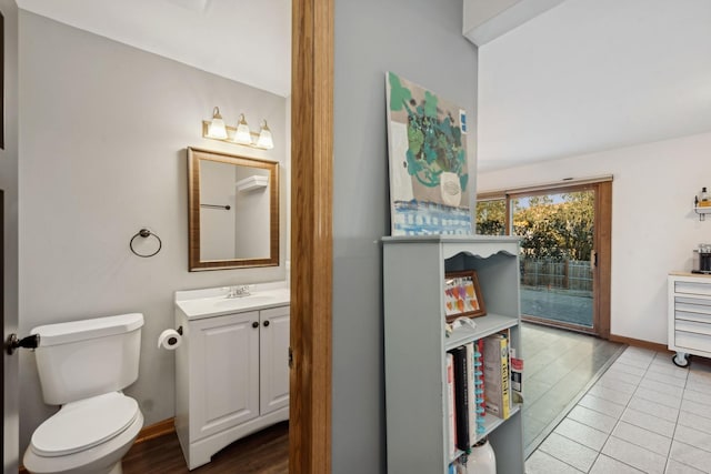 bathroom featuring tile patterned floors, toilet, and vanity