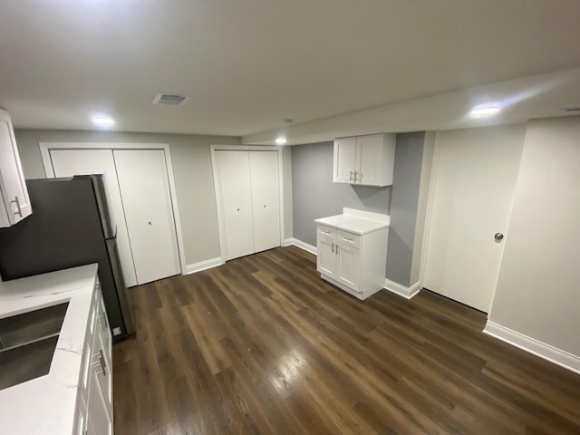 kitchen with white cabinetry, sink, stainless steel fridge, and dark hardwood / wood-style floors