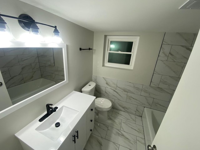 full bathroom with tile walls, toilet, vanity, and shower / bathing tub combination