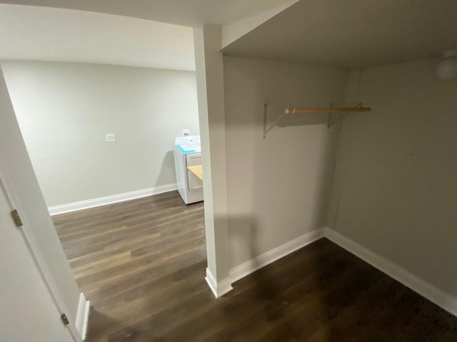 spacious closet with dark hardwood / wood-style flooring and washer / clothes dryer