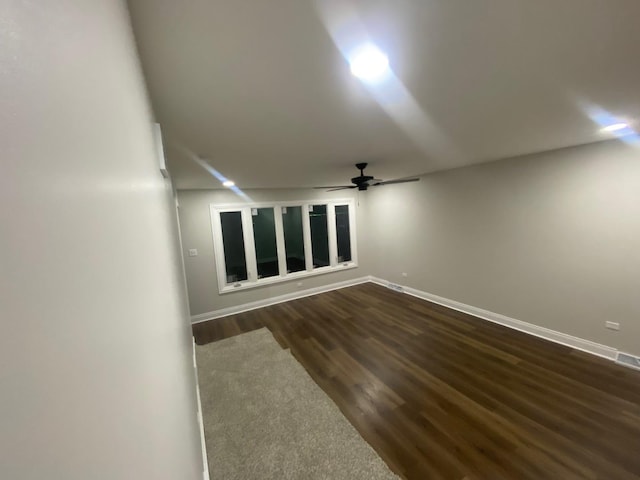 empty room featuring ceiling fan and dark hardwood / wood-style floors