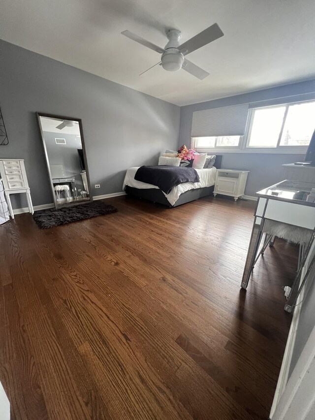 bedroom featuring dark wood-style floors and a ceiling fan