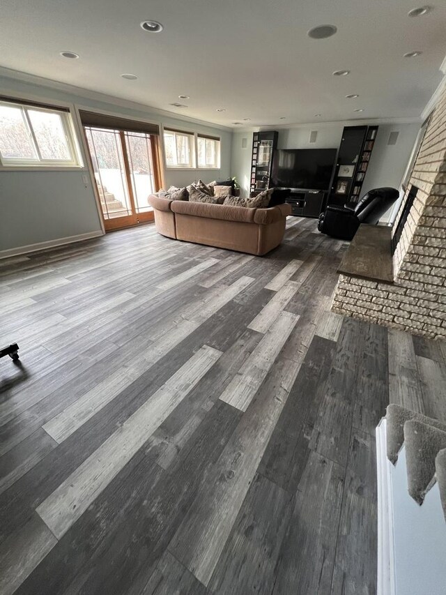 workout room featuring wooden walls, an accent wall, a ceiling fan, baseboards, and dark wood finished floors