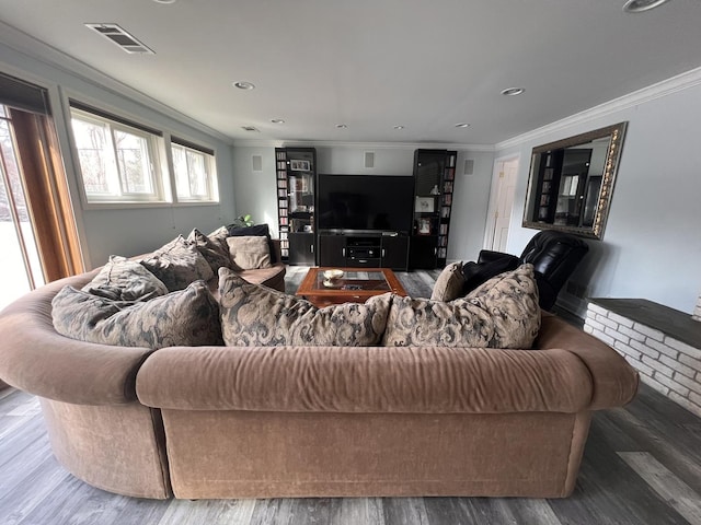 living room featuring ornamental molding, recessed lighting, visible vents, and wood finished floors