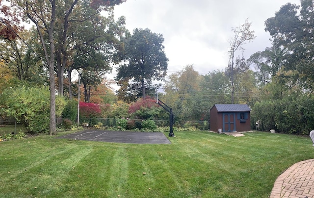 view of yard featuring an outbuilding, a storage shed, and fence private yard