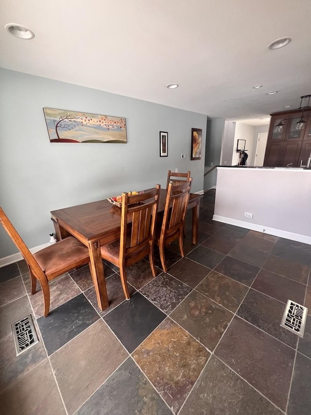 dining space featuring baseboards, visible vents, and recessed lighting