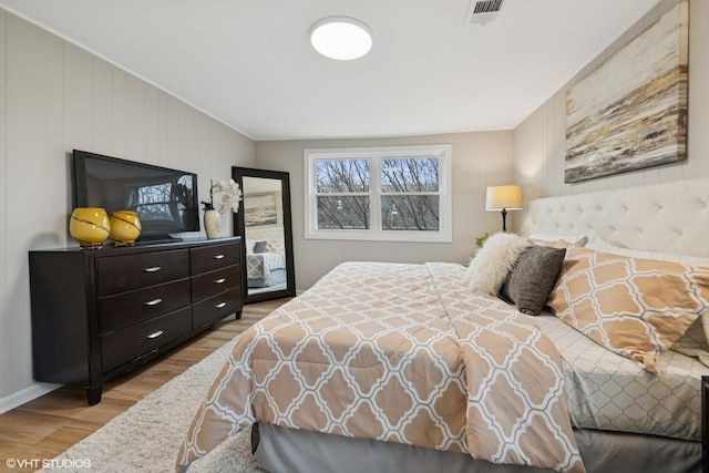 bedroom with wood finished floors and visible vents