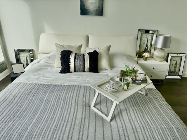 bedroom with baseboards and wood finished floors