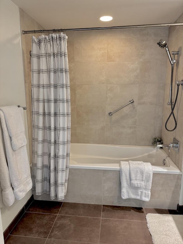 bathroom with tile patterned flooring and tiled shower / bath