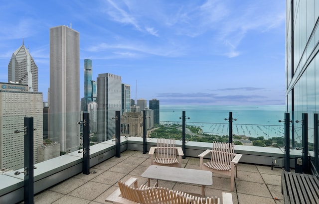 balcony with a water view and a view of city