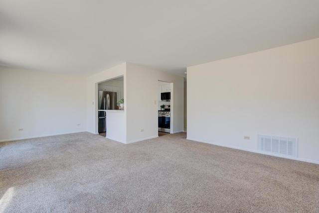 unfurnished room with light carpet, baseboards, and visible vents