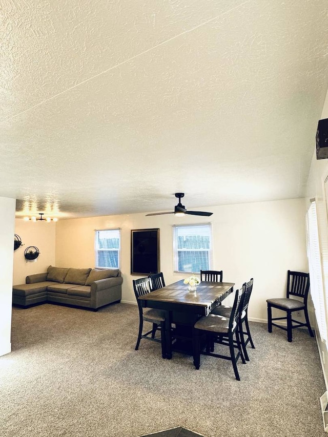 dining room with plenty of natural light, a ceiling fan, and light colored carpet