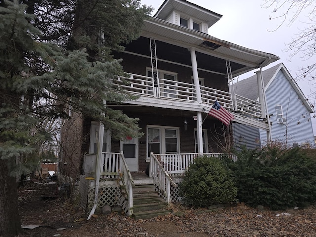 view of front of home featuring a balcony and a porch