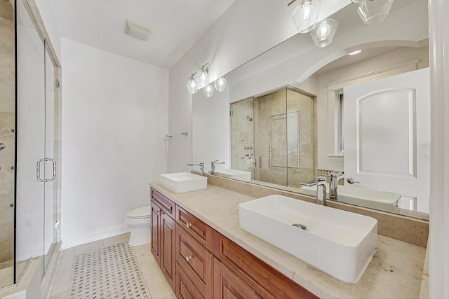 bathroom featuring a stall shower, a sink, and tile patterned floors