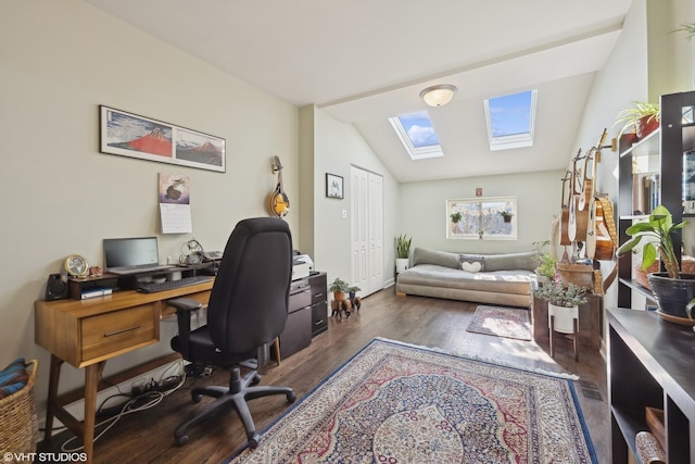 office area with vaulted ceiling with skylight and dark wood finished floors