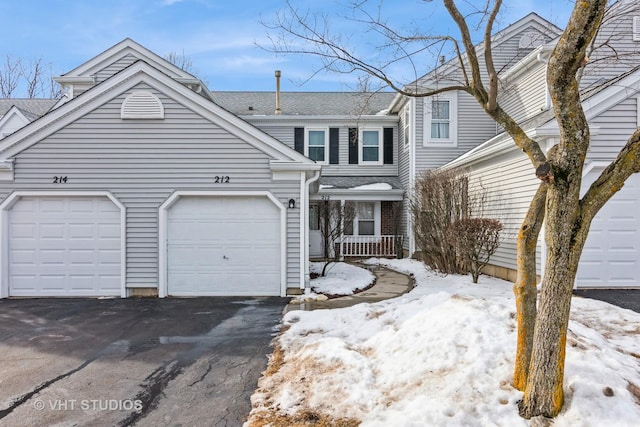 view of front of house with a garage and aphalt driveway