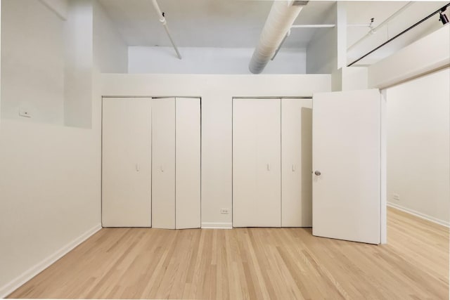 interior space with light wood-style floors and baseboards