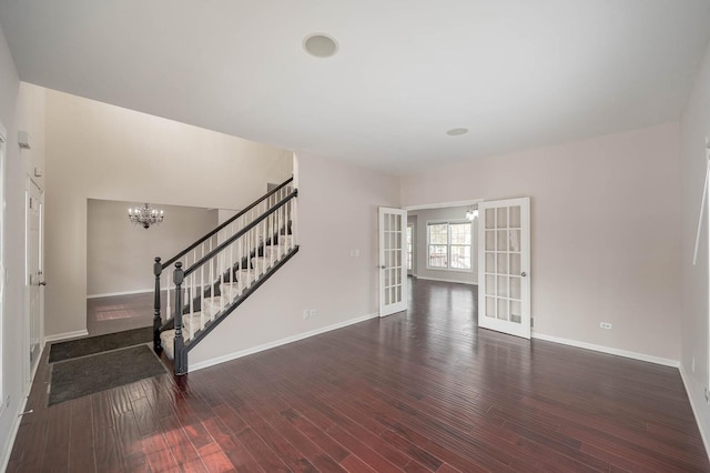 interior space featuring dark wood-type flooring, french doors, stairway, and baseboards