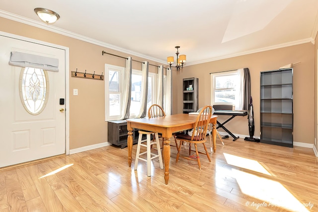 dining room with baseboards, ornamental molding, light wood-style flooring, and a notable chandelier