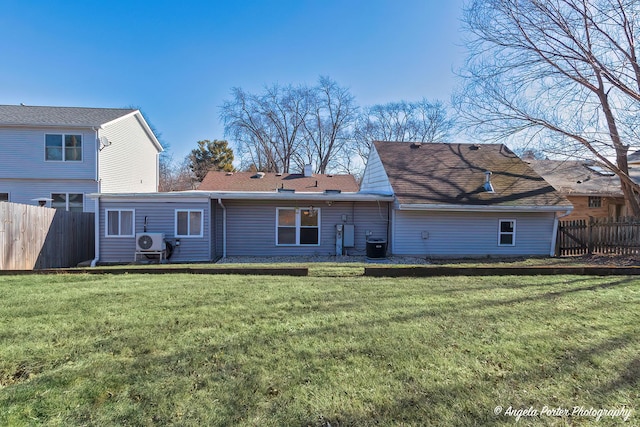 back of house featuring a yard, ac unit, and fence