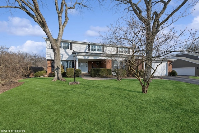 traditional-style home featuring aphalt driveway, brick siding, an attached garage, and a front lawn