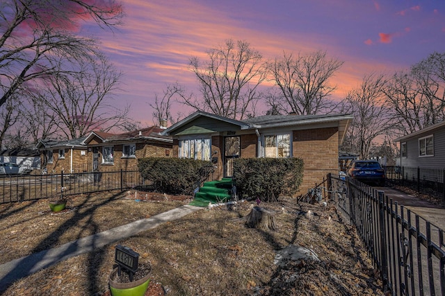 view of front of house with brick siding and fence