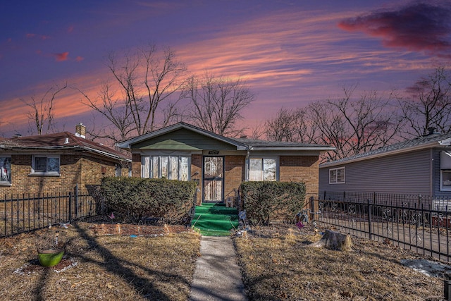 bungalow with brick siding and fence