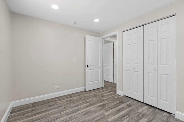 unfurnished bedroom featuring a closet and light hardwood / wood-style flooring