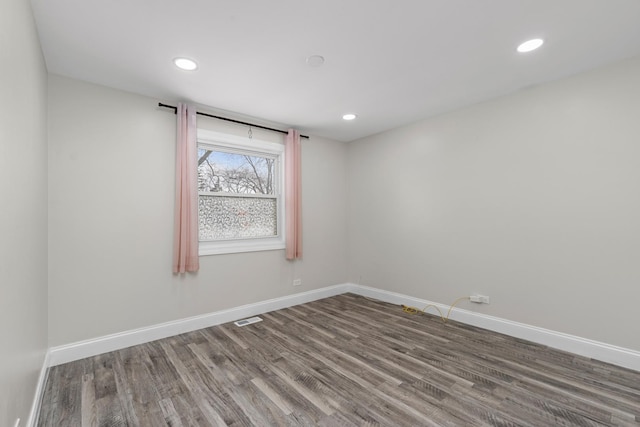 unfurnished room featuring hardwood / wood-style flooring