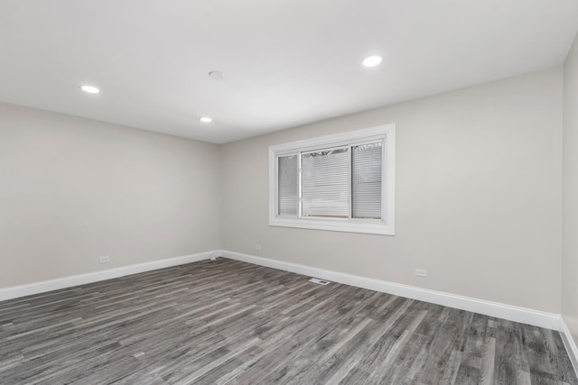 empty room with dark hardwood / wood-style flooring