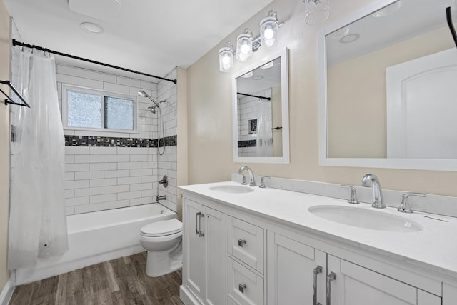 full bathroom with wood-type flooring, vanity, toilet, and shower / bath combination with curtain