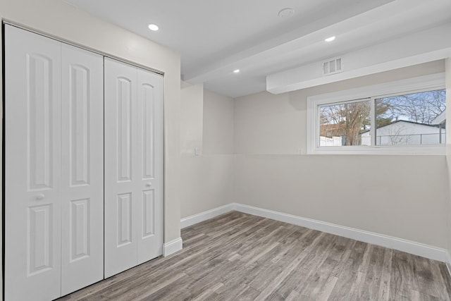 unfurnished bedroom with a closet and light hardwood / wood-style flooring