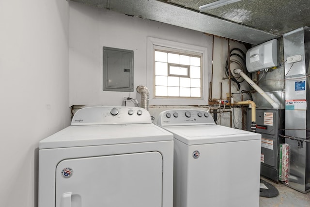 laundry area with heating unit, electric panel, and separate washer and dryer