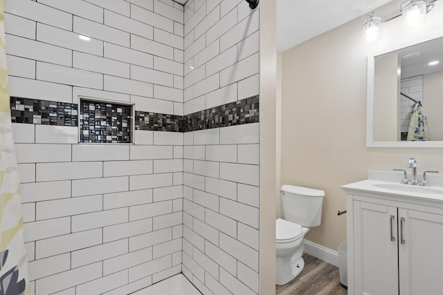 bathroom with toilet, vanity, a shower with curtain, and wood-type flooring