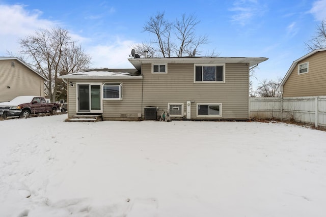 snow covered property featuring central AC unit