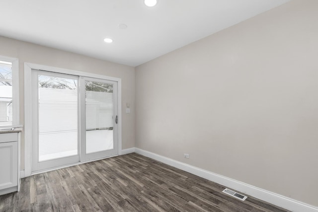 unfurnished room featuring dark wood-type flooring