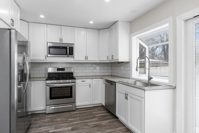 kitchen featuring white cabinetry, stainless steel appliances, and sink