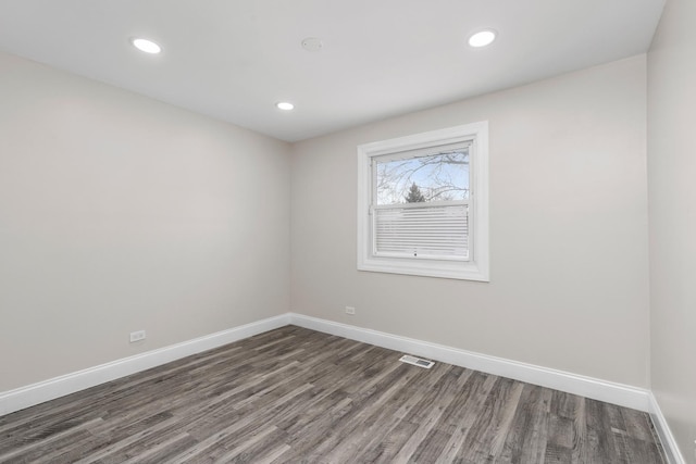 spare room with dark hardwood / wood-style flooring