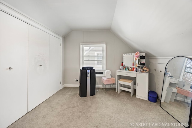 interior space featuring vaulted ceiling and light colored carpet