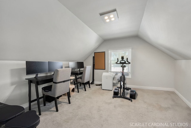 office space featuring carpet floors, baseboards, and vaulted ceiling