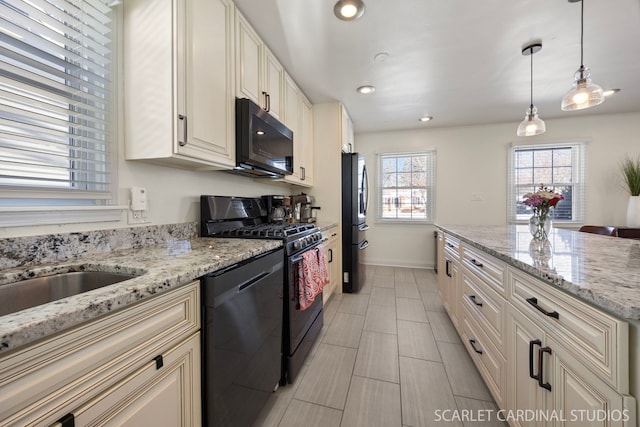 kitchen featuring pendant lighting, recessed lighting, black appliances, light stone countertops, and baseboards