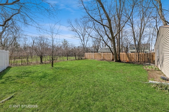 view of yard with a fenced backyard