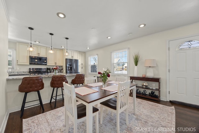 dining area with baseboards, dark wood finished floors, and recessed lighting