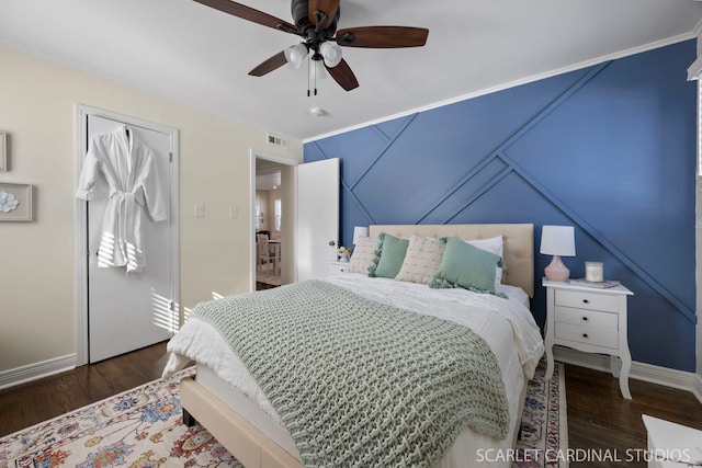 bedroom with ceiling fan, visible vents, baseboards, and wood finished floors