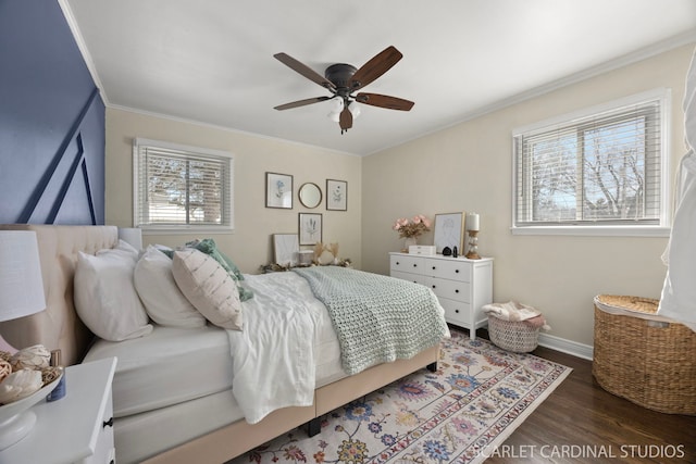 bedroom with baseboards, wood finished floors, a ceiling fan, and crown molding