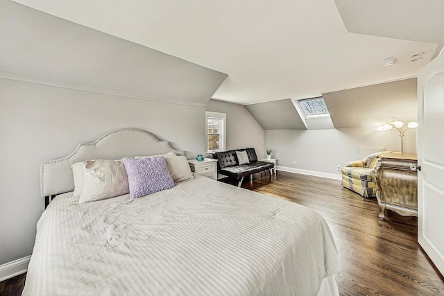 bedroom featuring dark wood-type flooring, baseboards, and lofted ceiling with skylight