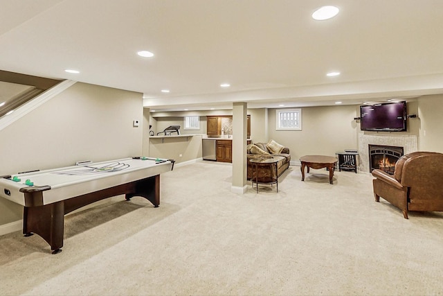 game room featuring baseboards, recessed lighting, a fireplace, and light colored carpet